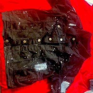 Black denim jacket with white paint splashes on it